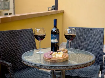 a table with two wine glasses and a bottle of wine at Sosta dei Garibaldini in Campofelice di Roccella