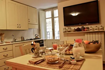 a kitchen with a table with food on it at VUCCIRIA 57 locazione turistica nel cuore pulsante della movida! in Palermo