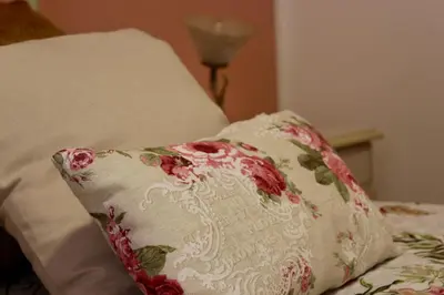 a pillow sitting on top of a bed at VUCCIRIA 57 locazione turistica nel cuore pulsante della movida! in Palermo