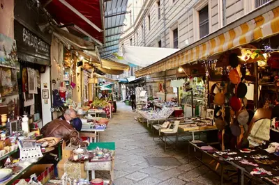 a market with people sitting at tables in a street at VUCCIRIA 57 locazione turistica nel cuore pulsante della movida! in Palermo