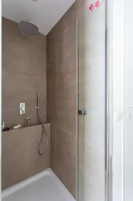 a shower with a glass door in a bathroom at Stabile Central Studios in Palermo