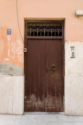 a large wooden door on a building at Maison Tulip in Palermo