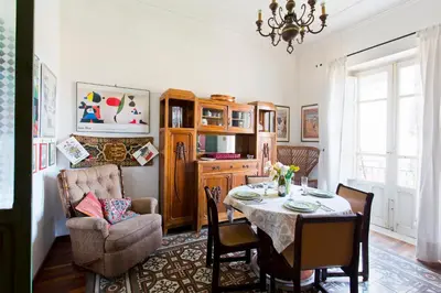 a dining room with a table and a chair at Maison Tulip in Palermo