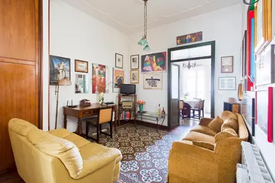 a living room with two couches and a dining room at Maison Tulip in Palermo