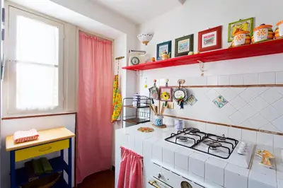 a kitchen with a stove and a counter top at Maison Tulip in Palermo