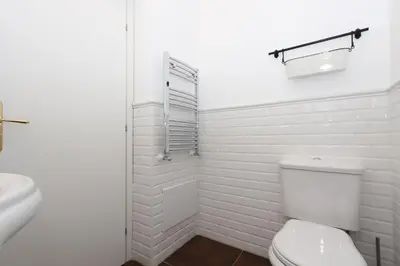 a white bathroom with a toilet and a sink at Le case d'un tempo in Palermo