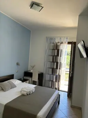 a bedroom with a bed with two towels on it at Bed And Breakfast Turi in Castelluzzo