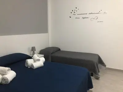 a room with two beds with towels on them at La Ruota B&B in Terrasini