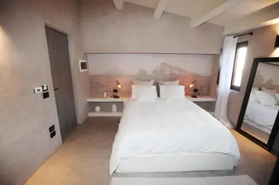 a bedroom with a large white bed and two lamps at Casa Nostra Luxury Suites & Spa in Palermo