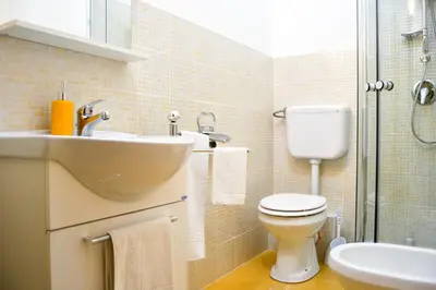 a bathroom with a sink and a toilet and a shower at Cheap in Center in Palermo