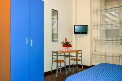 a room with a bed and a table with two chairs at Cheap in Center in Palermo