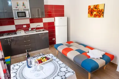 a kitchen with a couch and a table in a room at Da Ida e Gianni in Castellammare del Golfo