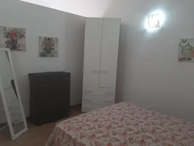 a bedroom with a bed and a dresser and a mirror at Da Ida e Gianni in Castellammare del Golfo