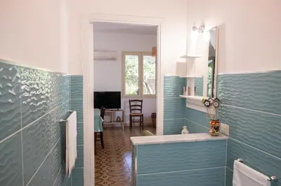 a bathroom with a sink and a mirror at Isabel House in Isola delle Femmine