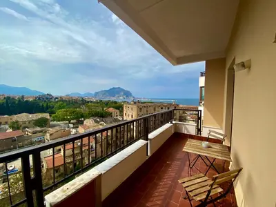 a balcony with a table and a view of the city at CasaMare Sant'Erasmo Sea View apartment & suites in Palermo