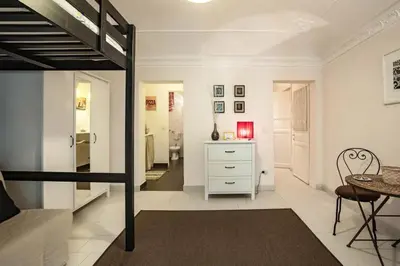 a living room with a loft bed and a bedroom at Trip Rooms in Palermo