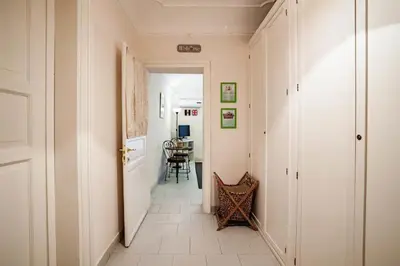a hallway with a table and a chair in a room at Trip Rooms in Palermo