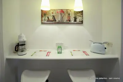 a bathroom counter with three chairs and a sink at Trip Rooms in Palermo