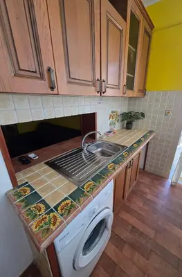 a kitchen with a sink and a washing machine at PTA Appartamento Girasole in Palermo