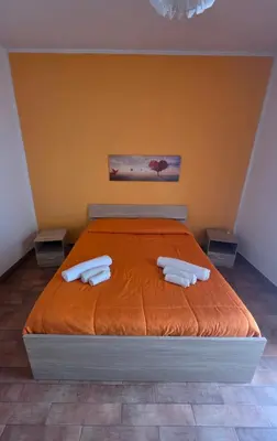 a bedroom with a bed with two towels on it at PTA Appartamento Girasole in Palermo