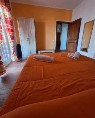 a large orange bed with two towels on top of it at PTA Appartamento Girasole in Palermo