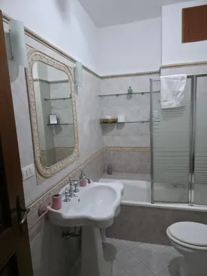 a bathroom with a sink and a toilet and a tub at PTA Appartamento Girasole in Palermo