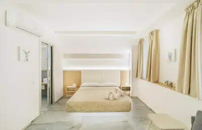 a bedroom with a bed with a dog laying on the floor at Oasi del Golfo Suites B&B in Castellammare del Golfo