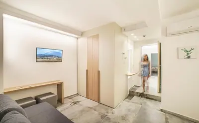 a woman walking down the hallway of a house at Oasi del Golfo Suites B&B in Castellammare del Golfo