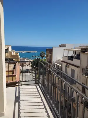 a view of the ocean from the balcony of a building at Palazzo del Golfo in Castellammare del Golfo