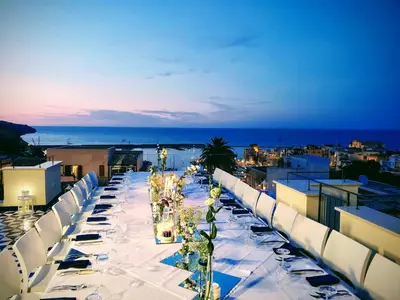a long table on the roof of a building at Palazzo del Golfo Penthouse in Castellammare del Golfo