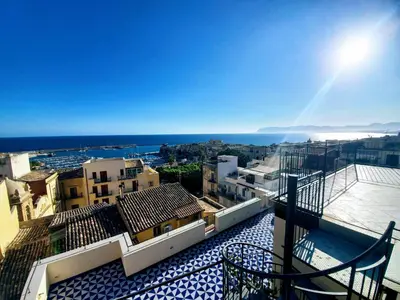 a view of a city from the balcony of a building at Palazzo del Golfo Penthouse in Castellammare del Golfo