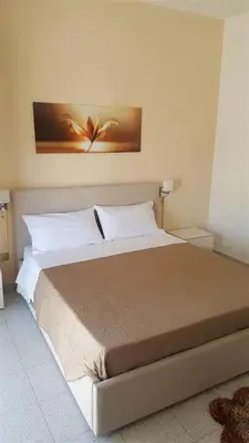 a bedroom with a large bed with white pillows at Giusy's Place 2.0 in Campofelice di Roccella