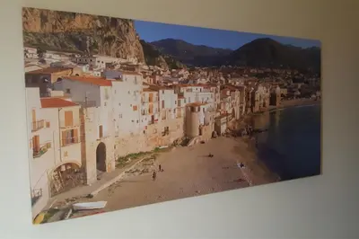 a painting of a town with a beach and buildings at Giusy's Place 2.0 in Campofelice di Roccella