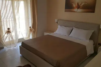 a bedroom with a large bed and a window at Giusy's Place 2.0 in Campofelice di Roccella