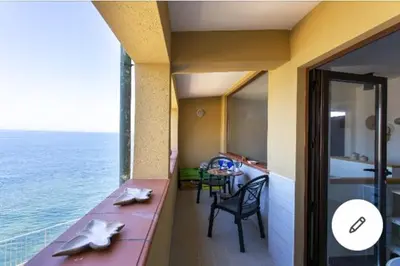 a room with a table and a view of the ocean at la casa al mare in Trappeto
