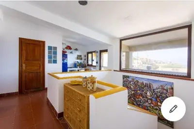 a kitchen with a counter and a large window at la casa al mare in Trappeto