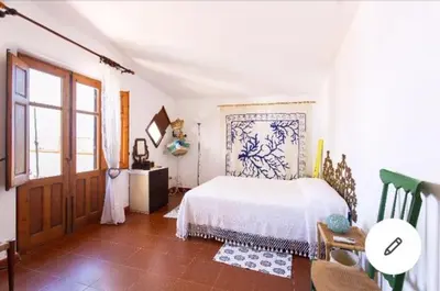 a bedroom with a white bed and a window at la casa al mare in Trappeto