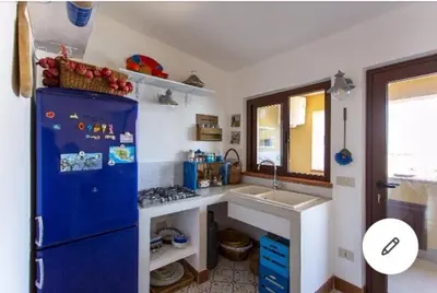 a kitchen with a blue refrigerator and a sink at la casa al mare in Trappeto