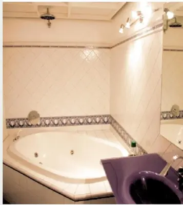 a bathroom with a tub and a purple sink at Baru's House in Palermo