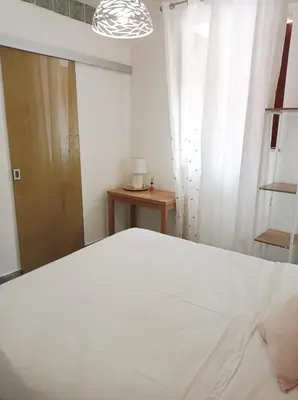 a bedroom with a white bed and a window at Appartamento di Giò in Palermo