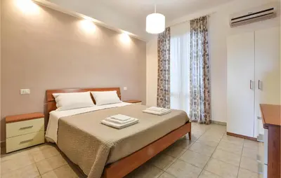 a bedroom with a bed with two towels on it at Villa Mucera in Ficarazzi
