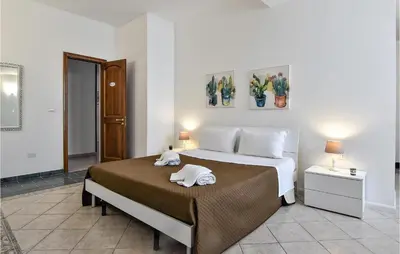 a bedroom with a bed with two towels on it at Villa Mucera in Ficarazzi