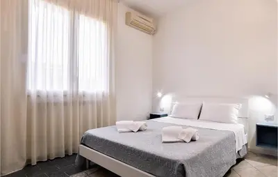 a bedroom with a bed with two towels on it at Villa Mucera in Ficarazzi