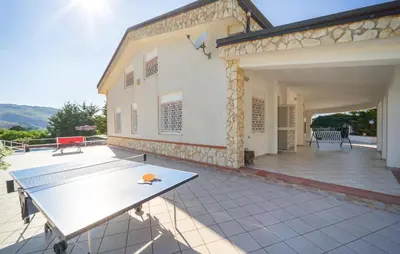 a ping pong table on the patio of a house at 5 Bedroom Nice Home In Monreale in Monreale