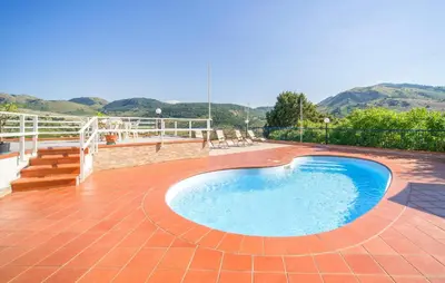 a swimming pool on a patio with mountains in the background at 5 Bedroom Nice Home In Monreale in Monreale