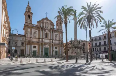 a large building with palm trees in front of it at H Urban in Palermo