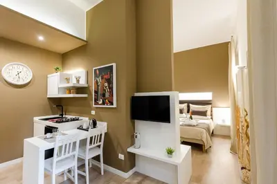 a small living room with a television and a bed at Residenze Chamur Via Giuseppe Sciuti in Palermo