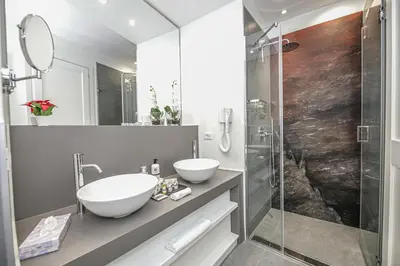 a bathroom with two sinks and a shower at Residenze Chamur Via Giuseppe Sciuti in Palermo