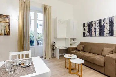 a living room with a couch and a table at Residenze Chamur Via Giuseppe Sciuti in Palermo
