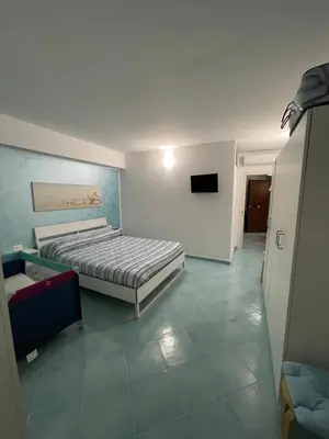 a bedroom with a bed and a flat screen tv at La casa di fronte la spiaggia di San Vito lo capo in San Vito lo Capo